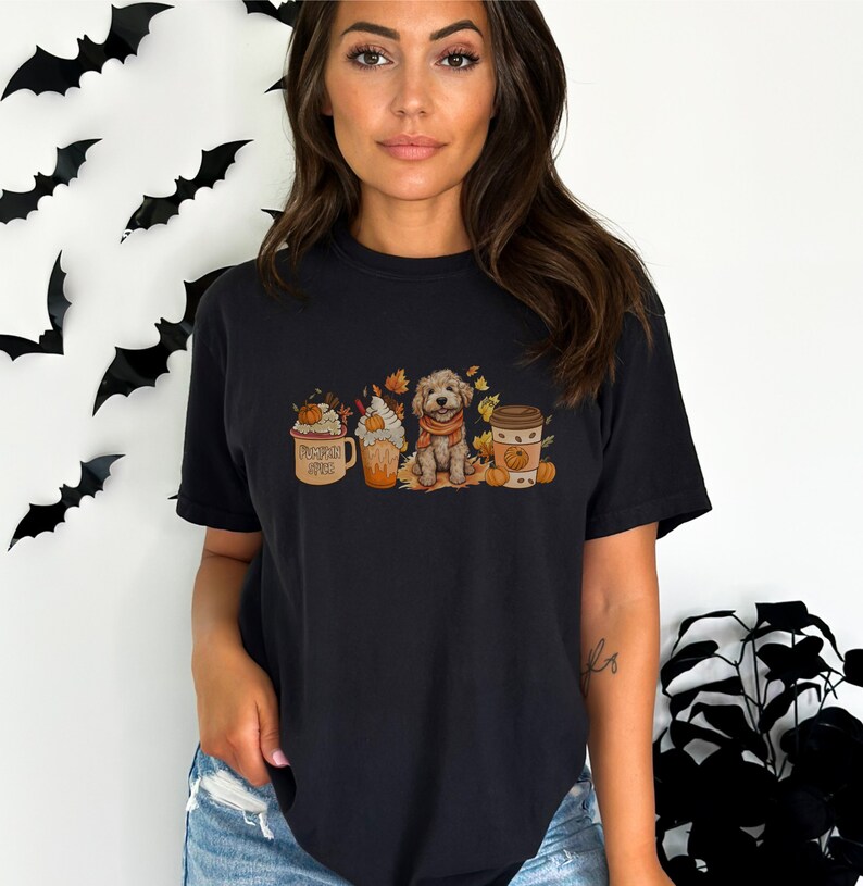 a woman wearing a black t - shirt with a picture of a dog in a