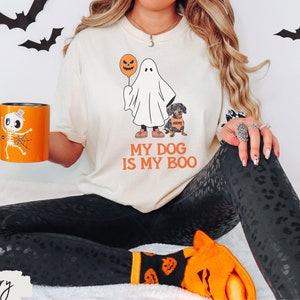 a woman sitting on a bed holding a coffee mug