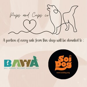 May include: A black and white line drawing of a dog with a heart above it. The text "Pups and Cups co" is above the dog. The text "A portion of every sale from this shop will be donated to:" is below the dog. Two logos are below the text. The first logo is for "BAWA" (Bali Animal Welfare Association) and the second logo is for "Soi Dog" with the website address "www.soidog.org".