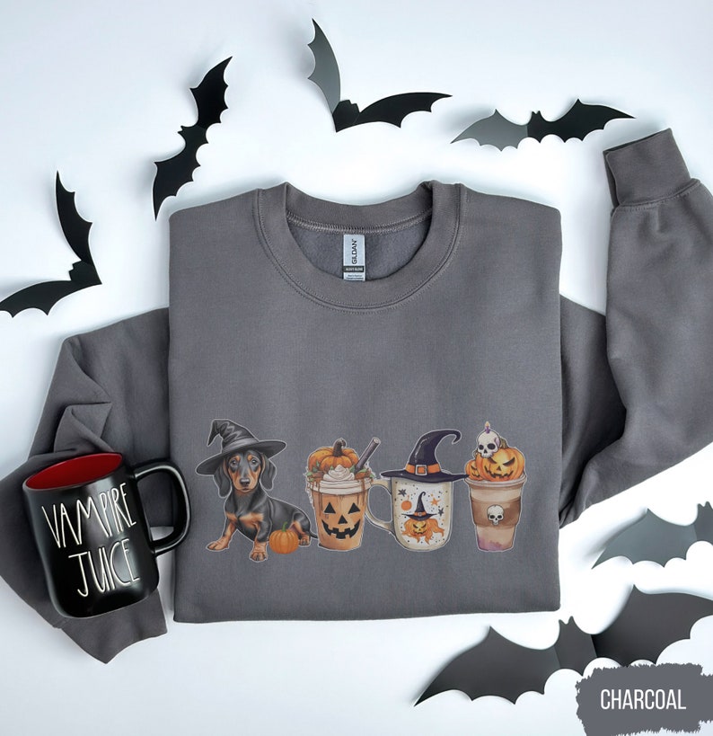 a gray shirt with a cup of coffee and some bats