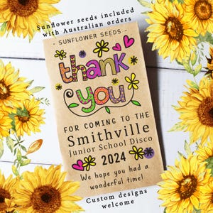 Può includere: Un sacchetto di semi con le parole "grazie" in lettere colorate, circondato da fiori e cuori. Il sacchetto è per lo Smithville Junior School Disco 2024. Semi di girasole inclusi con ordini australiani.