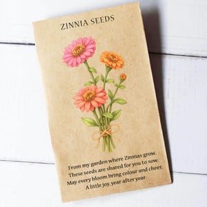 May include: A seed packet for Zinnias, featuring a floral illustration. The tan packet has the words "ZINNIA SEEDS" at the top. The illustration shows pink, orange, and coral zinnias tied with twine. Text at the bottom reads, "From my garden..."