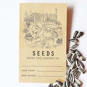 Pode incluir: Um cartão de papel castanho com uma ilustração a preto e branco de ferramentas de jardinagem e uma carriola. O cartão tem o texto "SEEDS FROM THE GARDEN OF" e linhas em branco para "seed name" e "date picked".