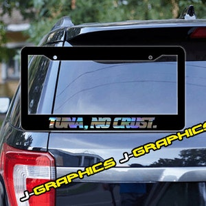 May include: Black license plate frame with a white border and the text "Tuna, No Crust." printed in yellow and rainbow iridescent letters.