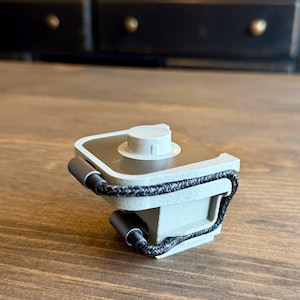 May include: A set of three ceramic mugs with a speckled, matte finish. The mugs are in shades of cream, light gray, and dark gray. Each mug has a simple, minimalist design, perfect for coffee or tea.