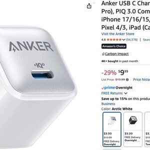 May include: A white Anker USB C charger block with a silver top and a blue USB port. The charger has the Anker logo and "+IQ" printed on it. It features a two-prong plug.