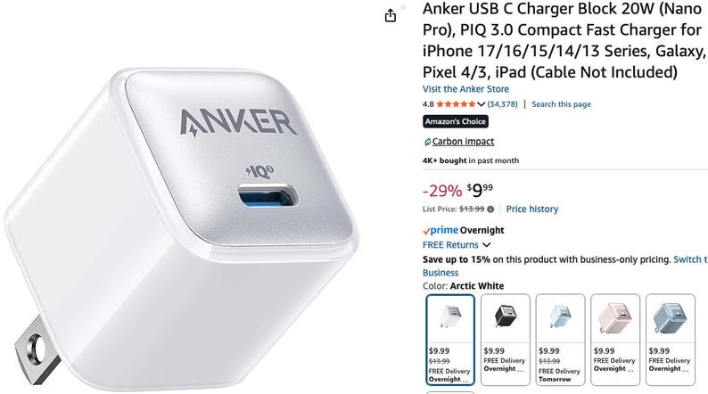 May include: A white Anker USB C charger block with a silver top and a blue USB port. The charger has the Anker logo and "+IQ" printed on it. It features a two-prong plug.