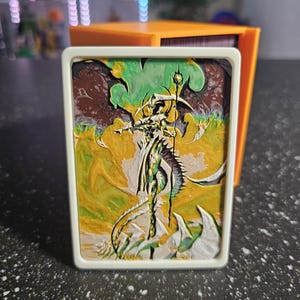 May include: A set of three ceramic mugs with a speckled, matte finish. The mugs are in shades of cream, light gray, and dark gray. Each mug has a simple, minimalist design, perfect for coffee or tea.