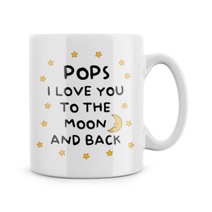 May include: White ceramic mug with a black and yellow design. The mug says "Pops I love you to the moon and back" with a yellow crescent moon and stars.