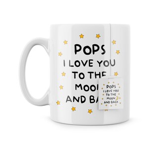 May include: White ceramic mug with a black and white design that says "Pops I Love You To The Moon And Back" with yellow stars and a tea bag that says "Pops I Love You To The Moon And Back".