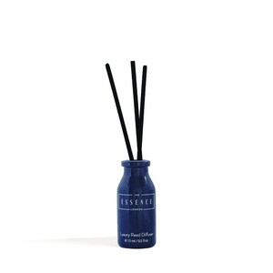 May include: A navy blue reed diffuser with black reeds. The bottle has a white label with the text "THE ESSENCE LONDON" and "Luxury Reed Diffuser e 15 ml / 0.5 fl.oz."