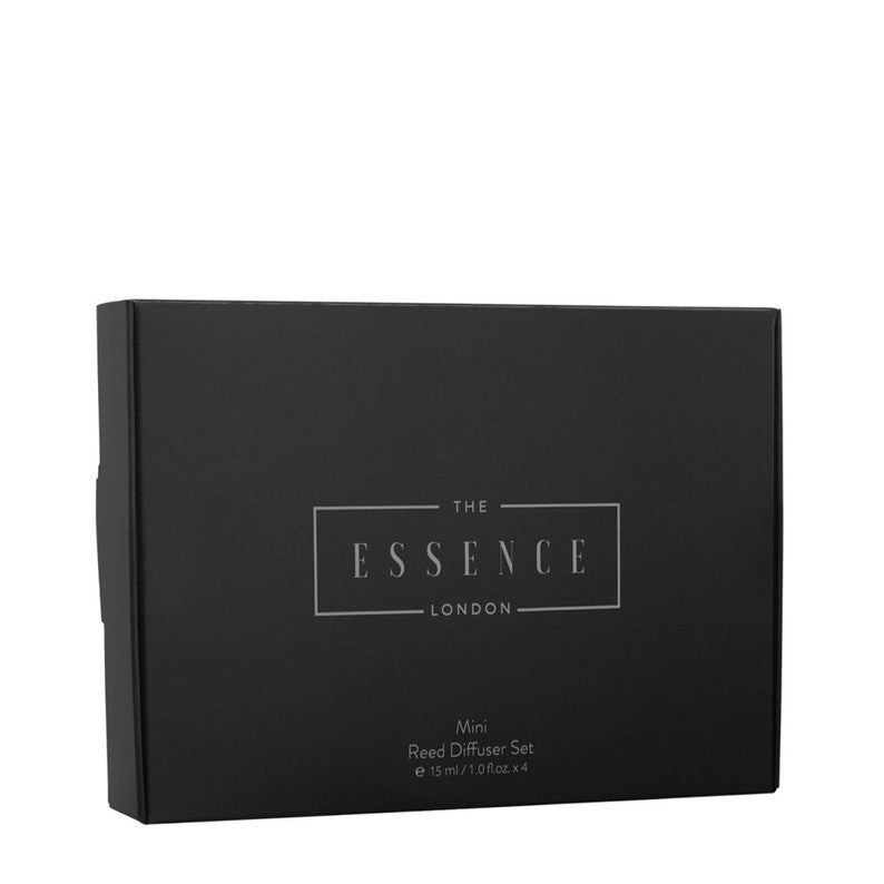 May include: A black rectangular box with the text "THE ESSENCE LONDON" in a silver font. Below the text is "Mini Reed Diffuser Set e 15 ml / 1.0 fl.oz. x 4". The box is angled slightly to the left against a white background.