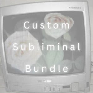 May include: A silver Toshiba television set displaying a screen with two white roses and the text Custom Subliminal Bundle in white lettering. The television features a curved screen, a front control panel with buttons, and a brand logo at the bottom.