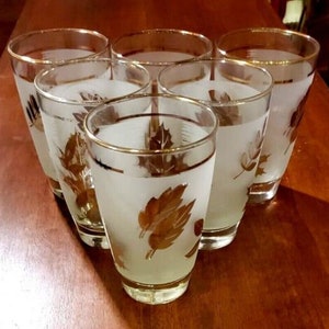 May include: Set of six frosted glass tumblers with gold leaf accents. Each glass features a different leaf design.