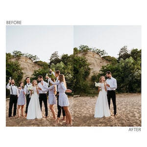 May include: A group of people in formal attire celebrating with champagne at a wedding. The bride and groom are in the center of the image, surrounded by their wedding party. The group is standing on a sandy beach with a cliff in the background.
