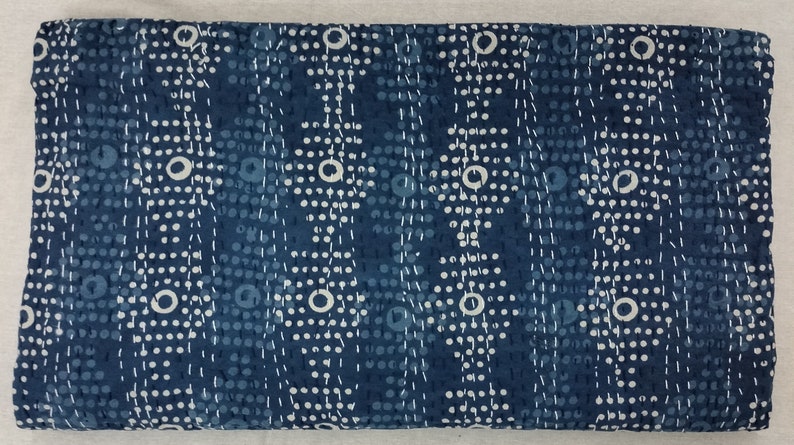 Pode incluir: Um tecido azul com um padr&atilde;o branco de pequenos pontos e c&iacute;rculos. O tecido tem uma superf&iacute;cie texturizada.