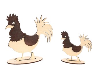May include: Two wooden rooster figurines, one larger than the other. Both roosters are brown and white with a brown head and tail feathers. The roosters are standing on a wooden base.