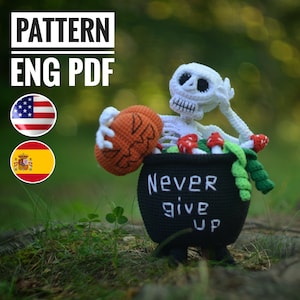 May include: Crochet amigurumi pattern for a skeleton holding a pumpkin and sitting in a cauldron with the text "Never give up". The pattern is available in English and Spanish.