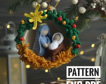 May include: Crocheted Christmas ornament featuring a nativity scene with Mary, Joseph, and baby Jesus. The ornament is decorated with a yellow star, green leaves, and red berries. The text "PATTERN ENG PDF" is visible below the ornament.
