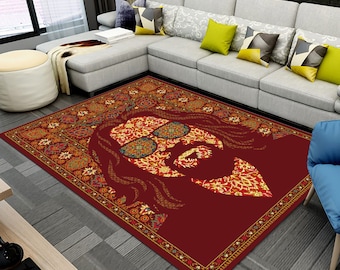 May include: Red area rug with a patterned border and a large, stylised image of a person wearing sunglasses. The person's face is made up of the same pattern as the border.