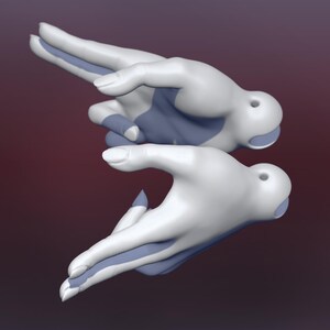 May include: Two white hands with blue accents are posed in a gesture of offering or giving. The hands are sculpted and appear to be made of ceramic.