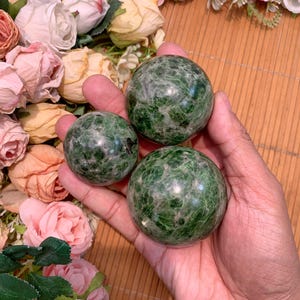 May include: Three green serpentine sphere orbs with a marbled pattern. The spheres are smooth and polished.