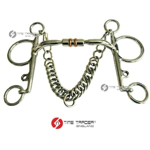 May include: Silver horse bit with a copper roller and a chain attached. The bit has two rings on each side and a centre bar with a copper roller. The chain is attached to the rings on the side of the bit.