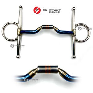 May include: A stainless steel horse bit with a blue and gold finish. The bit features a central roller with copper accents and the text "TIME TRADER ENGLAND". Designed for equestrian use.