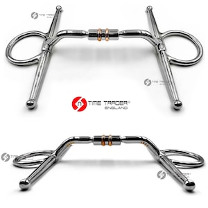 May include: A silver horse bit with two copper rings. The bit has a D-ring on each end and a center bar with a curved mouthpiece.