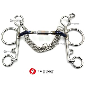 May include: A blue and silver horse bit with a chain attached. The bit has a copper centre and is marked "Time Trader England".