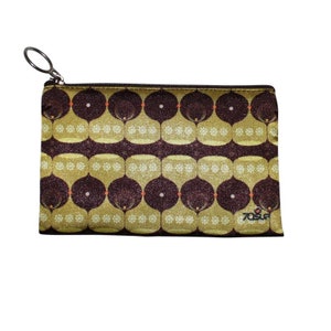 May include: A gold and brown zippered pouch with a geometric pattern. The pouch has a silver zipper pull and the text "70SUR" is printed on the bottom right corner.