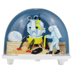 Sneeuwbol schudder astronaut maanlanding ruimteschip sneeuwstorm