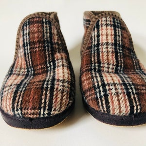 May include: A pair of brown and white plaid slippers with a dark brown sole.