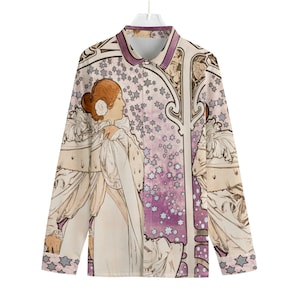 May include: A long-sleeved button-up shirt with a vintage art nouveau print featuring a woman in a flowing gown, a star-filled sky, and intricate floral designs in shades of purple, cream, and brown.