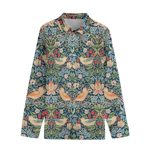 May include: Long-sleeved button-down shirt with a repeating pattern of birds, flowers, and strawberries in shades of blue, green, pink, and orange. The shirt has a classic collar and cuffs.