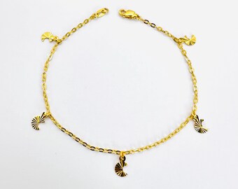 May include: A gold chain anklet with five small, decorative, fan-shaped charms.