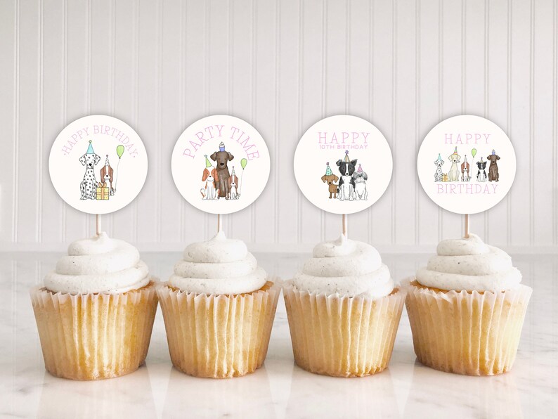 May include: Four cupcakes with white frosting and dog-themed cupcake toppers. The toppers feature illustrations of dogs wearing party hats and holding balloons. The text on the toppers reads "Happy Birthday", "Party Time", "Happy 10th Birthday", and "Happy Birthday".