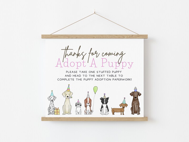May include: A sign that says "Thanks for coming Adopt A Puppy" with a line of cartoon dogs wearing party hats. The sign says "Please take one stuffed puppy and head to the next table to complete the puppy adoption paperwork!"