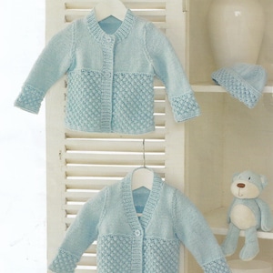 May include: Two light blue knitted baby cardigans with button fastenings. The cardigans feature a textured stitch pattern on the lower half. One cardigan has a round neckline and the other has a V-neckline.