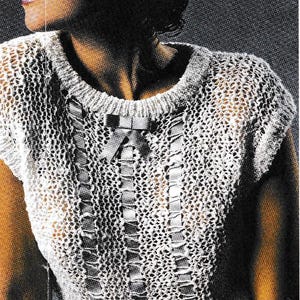 May include: A vintage, open-weave, short-sleeved top in a light colour, possibly white or cream. The top features a round neckline and a decorative ribbon detail down the front, with a small bow at the top. The style suggests a handmade or artisanal garment.