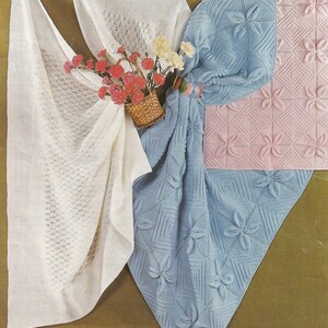 May include: Three knitted baby blankets in different colours and patterns. A white lace blanket, a blue blanket with a floral pattern, and a pink blanket with a floral pattern.