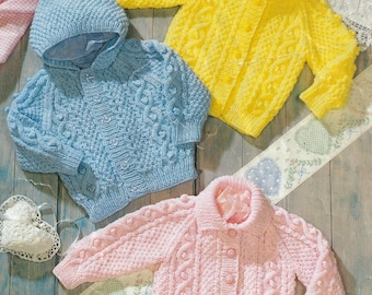May include: Three knitted baby cardigans in blue, yellow and pink. Each cardigan features a button fastening and a cable knit pattern. The blue cardigan has a hood.
