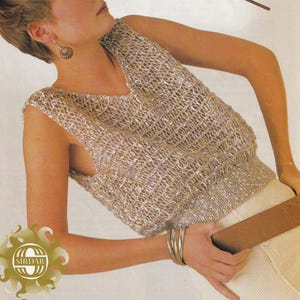 May include: A sleeveless knitted top with a V-neckline in a beige and silver color. The top is made of a lightweight, open-weave fabric.