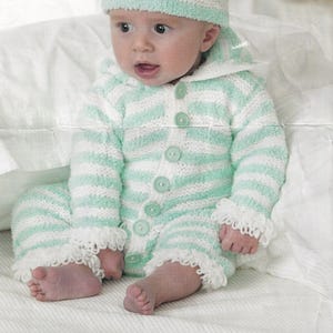 May include: A baby wearing a green and white striped knitted hooded jumpsuit with a white crocheted trim. The jumpsuit has a button closure and the baby is wearing a matching green and white striped knitted hat.