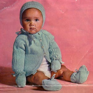 vintage knitting pattern for a collection of beautiful baby sets and bonnets age 6-18 months, cardigan, mittens, booties, and more