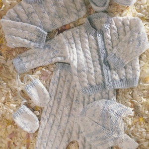 May include: A knitted baby outfit in blue and white with a cable knit pattern. The outfit includes a sweater, pants, hat, and booties.
