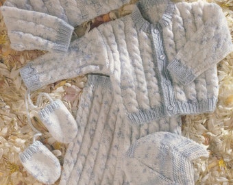 May include: A knitted baby outfit in blue and white with a cable knit pattern. The outfit includes a sweater, trousers, hat, and booties.