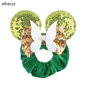 May include: Green velvet scrunchie with gold and green sequin butterfly ears.