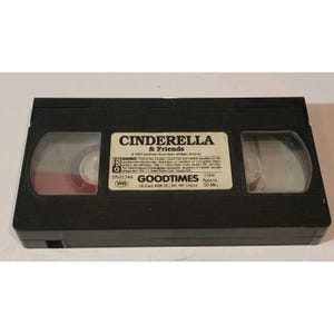 May include: A black VHS tape labeled "Cinderella & Friends" by GoodTimes. The label includes the FBI warning, copyright information, and the text "Color Approx. 30 Min."