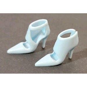 May include: Two light blue high-heeled shoes with pointed toes. The shoes have a strap around the ankle and a stiletto heel. The shoes are made of a smooth, solid material.
